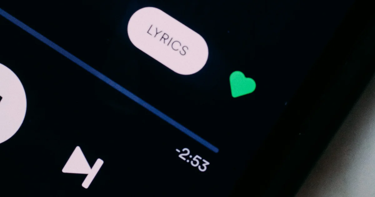 Close-up of a phone screen showing a Lyrics button on a music player